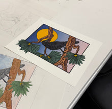 Load image into Gallery viewer, Raven blockprint sitting flat on white table. Print features a raven on pine branches with a full moon and dusk sky behind.